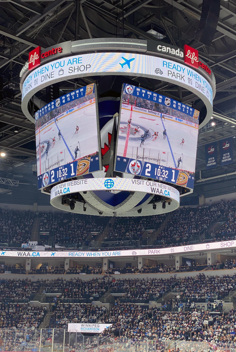 Photo of the Winnipeg Jets scoreboard that has an banner advertisements for WAA that we created.
